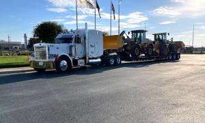 Hauling large earth-moving equipment, as seen here by Oden Transport in Oklahoma & Texas.