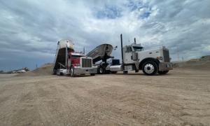 Two large truck involved in dirt hauling services by Oden Transport, with services in Texas, Oklahoma, Kansas & New Mexico.